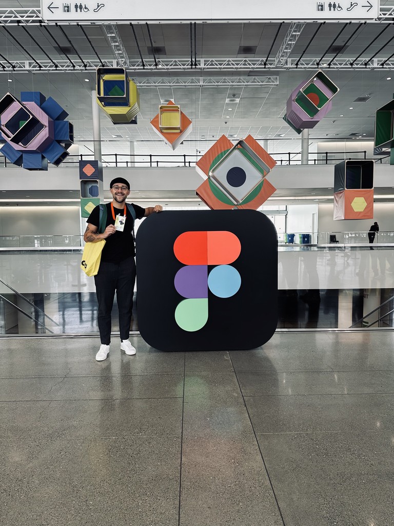 Álvaro at Figma Config, next to a giant Figma logo